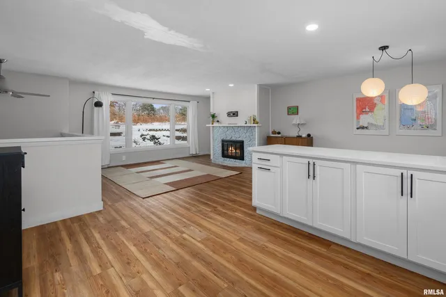 a spacious bedroom with a bed and a dresser