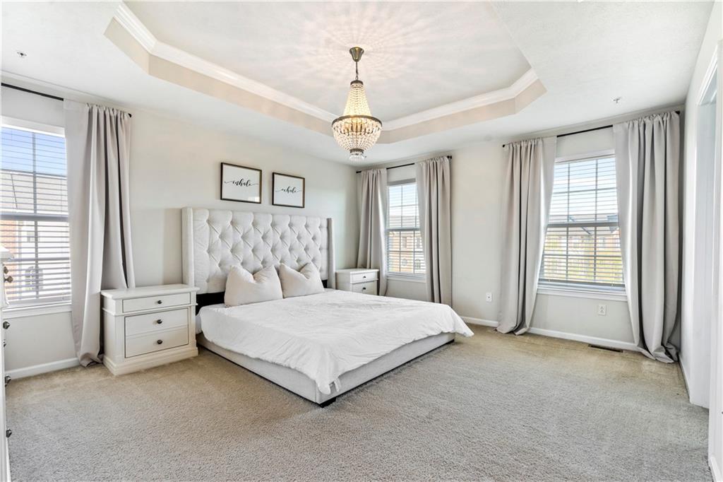 104 Pointe View Drive Mars, PA 16046 - Photo 13 of 25 a spacious bedroom with a bed chandelier and windows