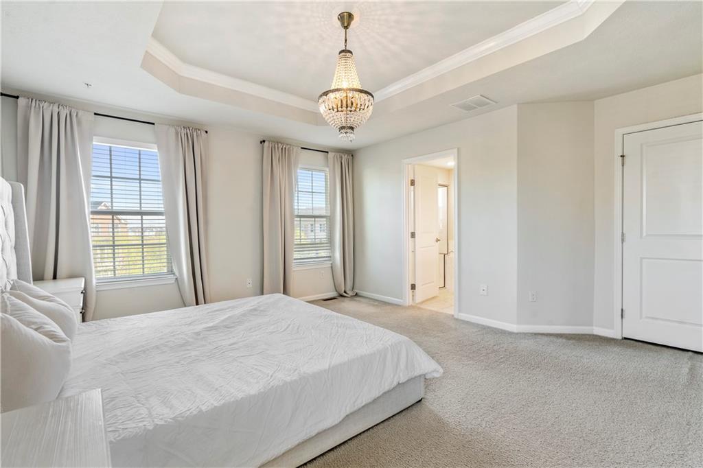 104 Pointe View Drive Mars, PA 16046 - Photo 14 of 25 a spacious bedroom with a bed and a chandelier