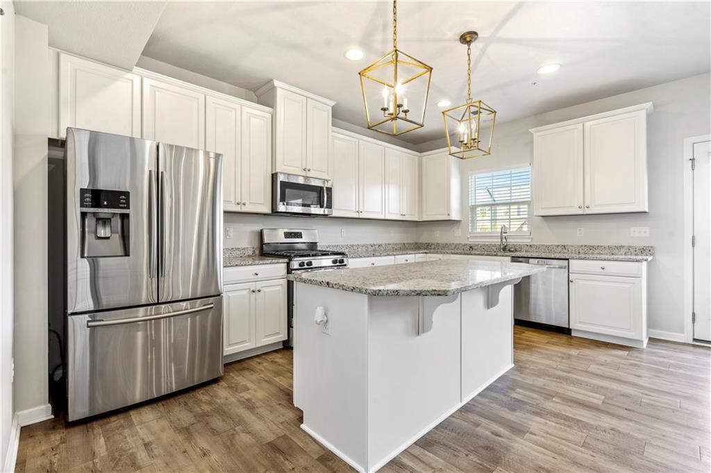 104 Pointe View Drive Mars, PA 16046 - Photo 8 of 25 a kitchen with kitchen island granite countertop a sink a center island stainless steel appliances and cabinets