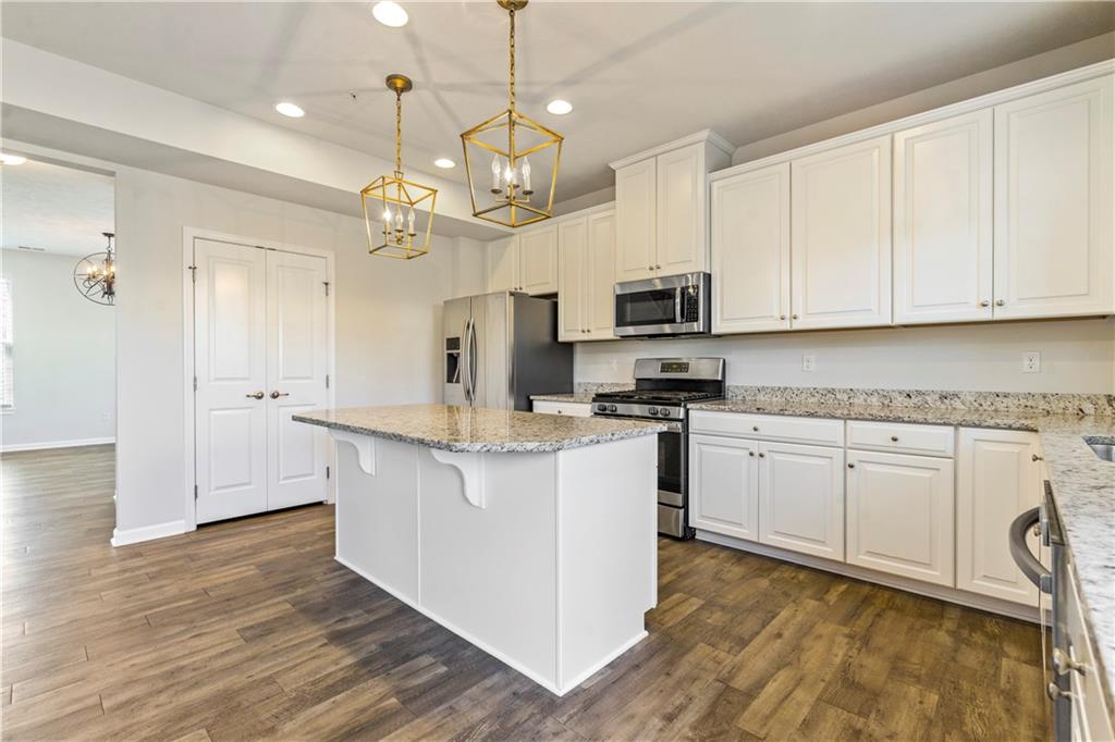 104 Pointe View Drive Mars, PA 16046 - Photo 10 of 25 a kitchen with kitchen island granite countertop a sink a counter space appliances and cabinets