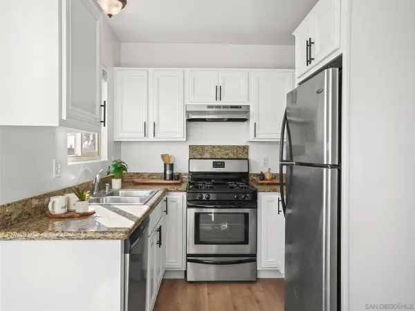 a kitchen with a sink stove and refrigerator