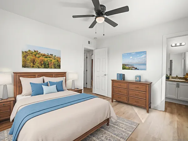 a bedroom with a large bed and a chandelier