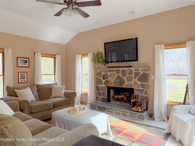 a living room with furniture and a fireplace