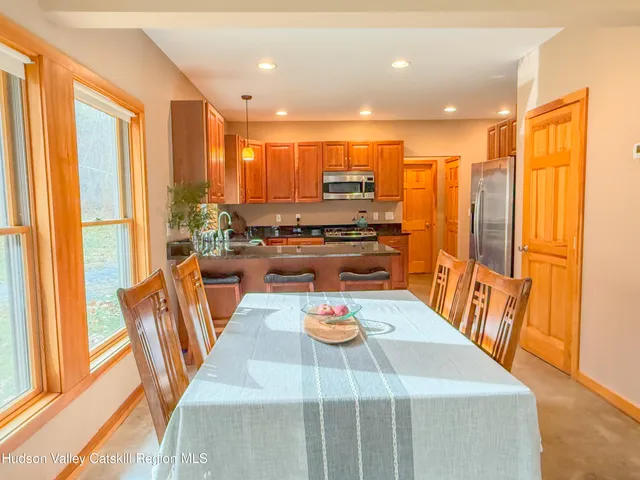 a view of a dining room with furniture window and outside view