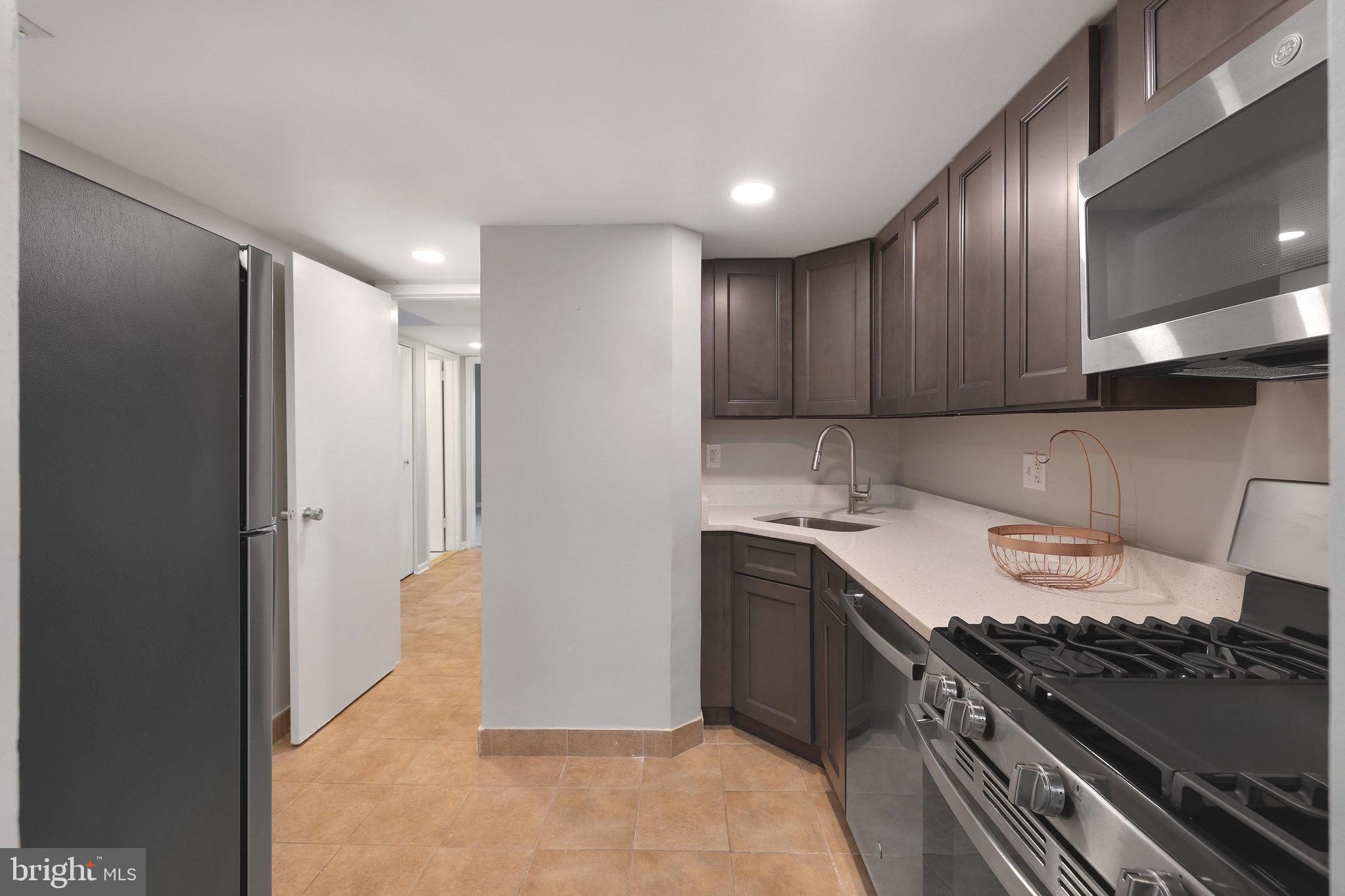 1554 Northgate Square, Unit 2A Reston, VA 20190 - Photo 4 of 11 a kitchen with a sink and a stove top oven