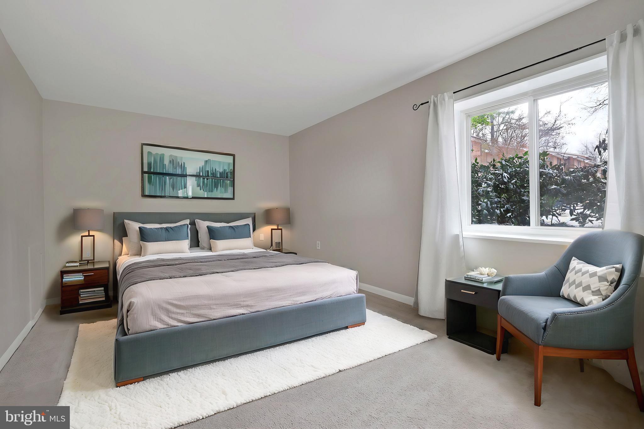 1554 Northgate Square, Unit 2A Reston, VA 20190 - Photo 6 of 11 a bedroom with a large bed couch and a window