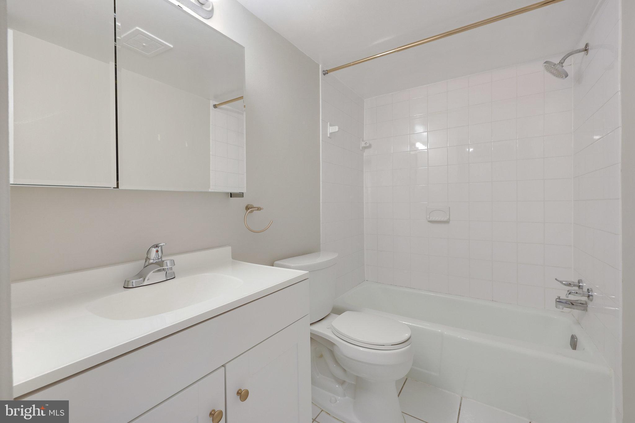 1554 Northgate Square, Unit 2A Reston, VA 20190 - Photo 7 of 11 a bathroom with a sink a toilet and shower