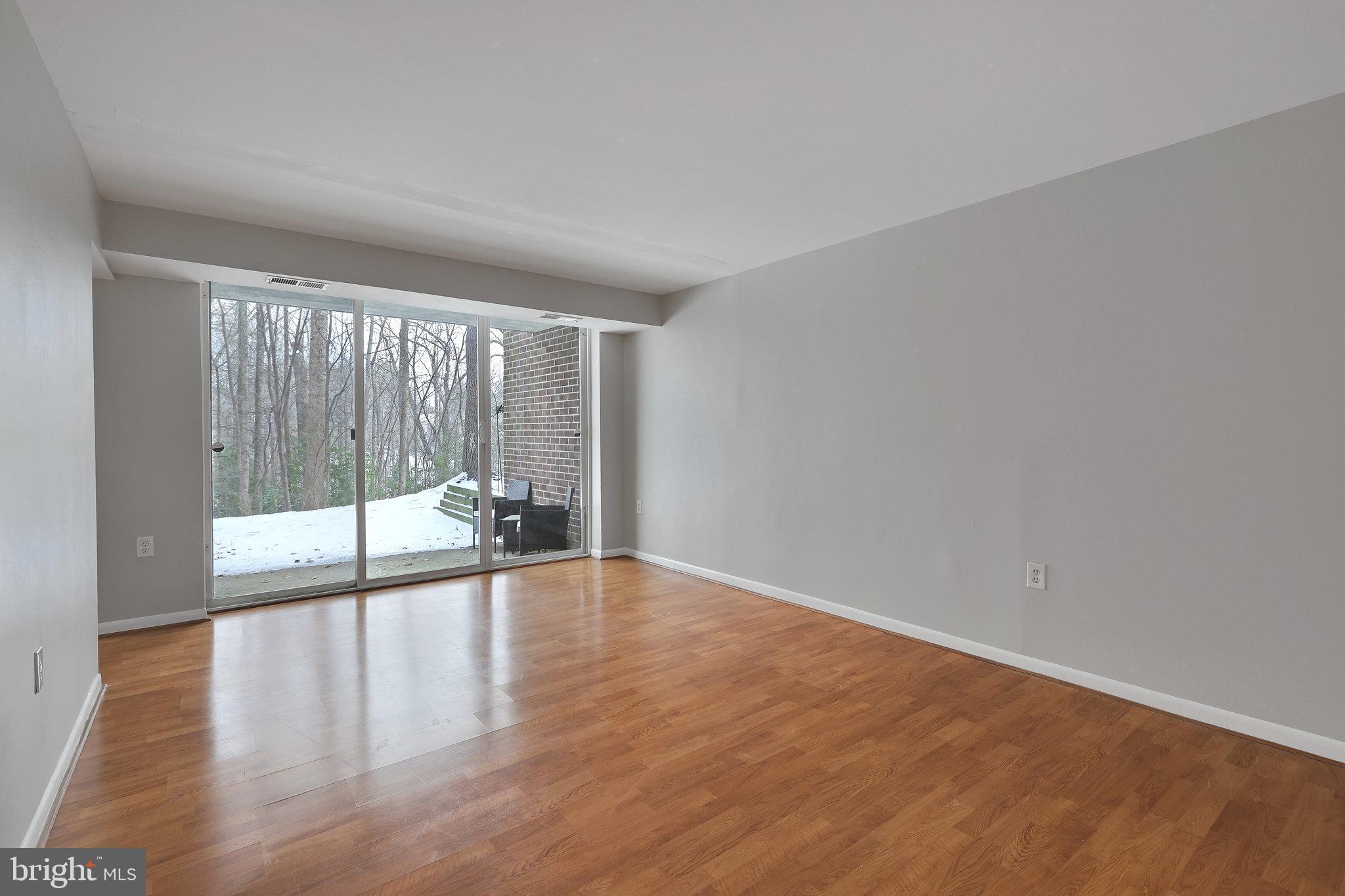 1554 Northgate Square, Unit 2A Reston, VA 20190 - Photo 8 of 11 a view of an empty room with wooden floor and a window