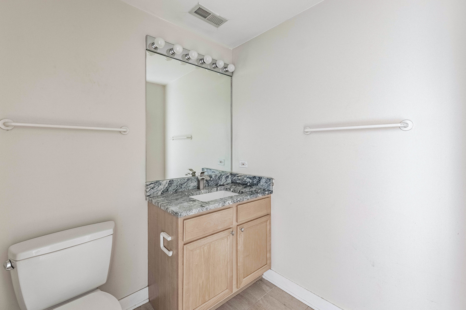 811 West 15th Place, Unit 806 Chicago, IL 60608 - Photo 19 of 35 a bathroom with a granite countertop sink and a mirror