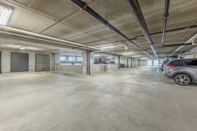 a view of parking garage with cars parked