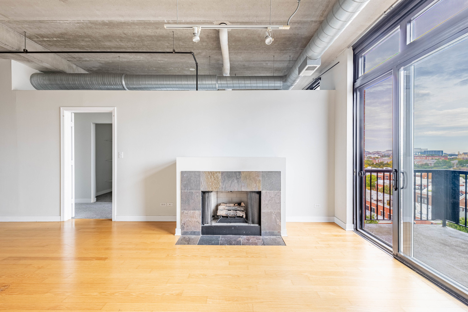 811 West 15th Place, Unit 806 Chicago, IL 60608 - Photo 5 of 35 a view of a livingroom with a fireplace and window
