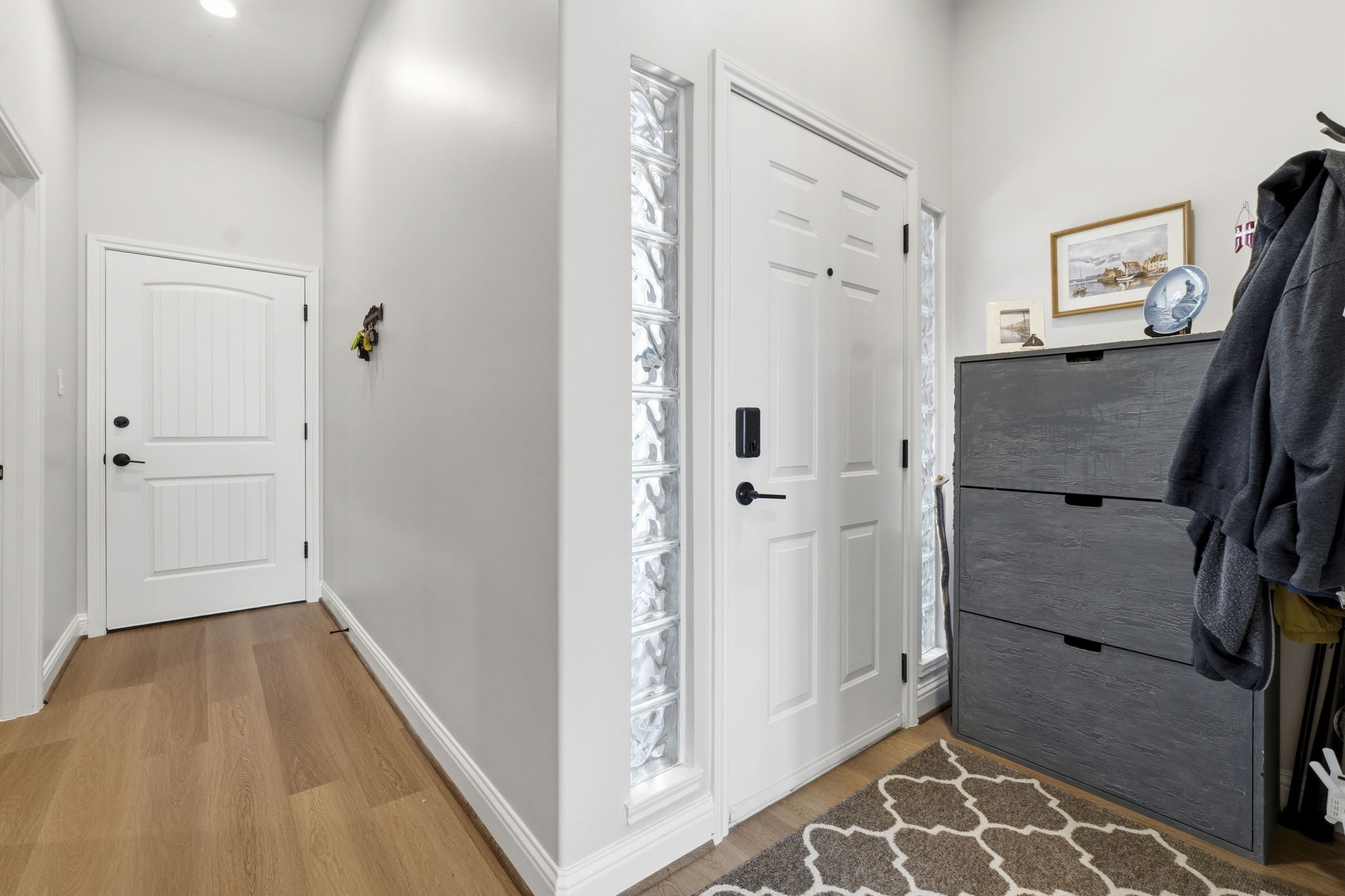 2 Key Harbour Conroe, TX 77356 - Photo 5 of 41 a view of a hallway with bathroom and wooden floor