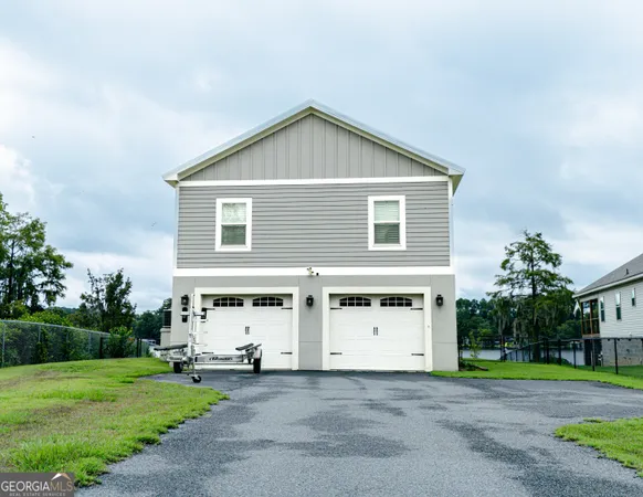 a view of a house with a yard and garage