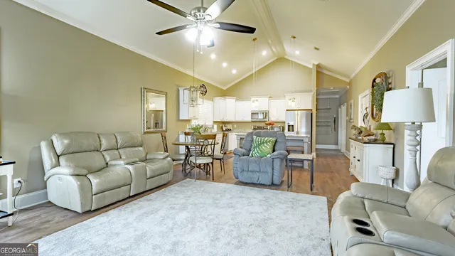 a living room with furniture and a chandelier
