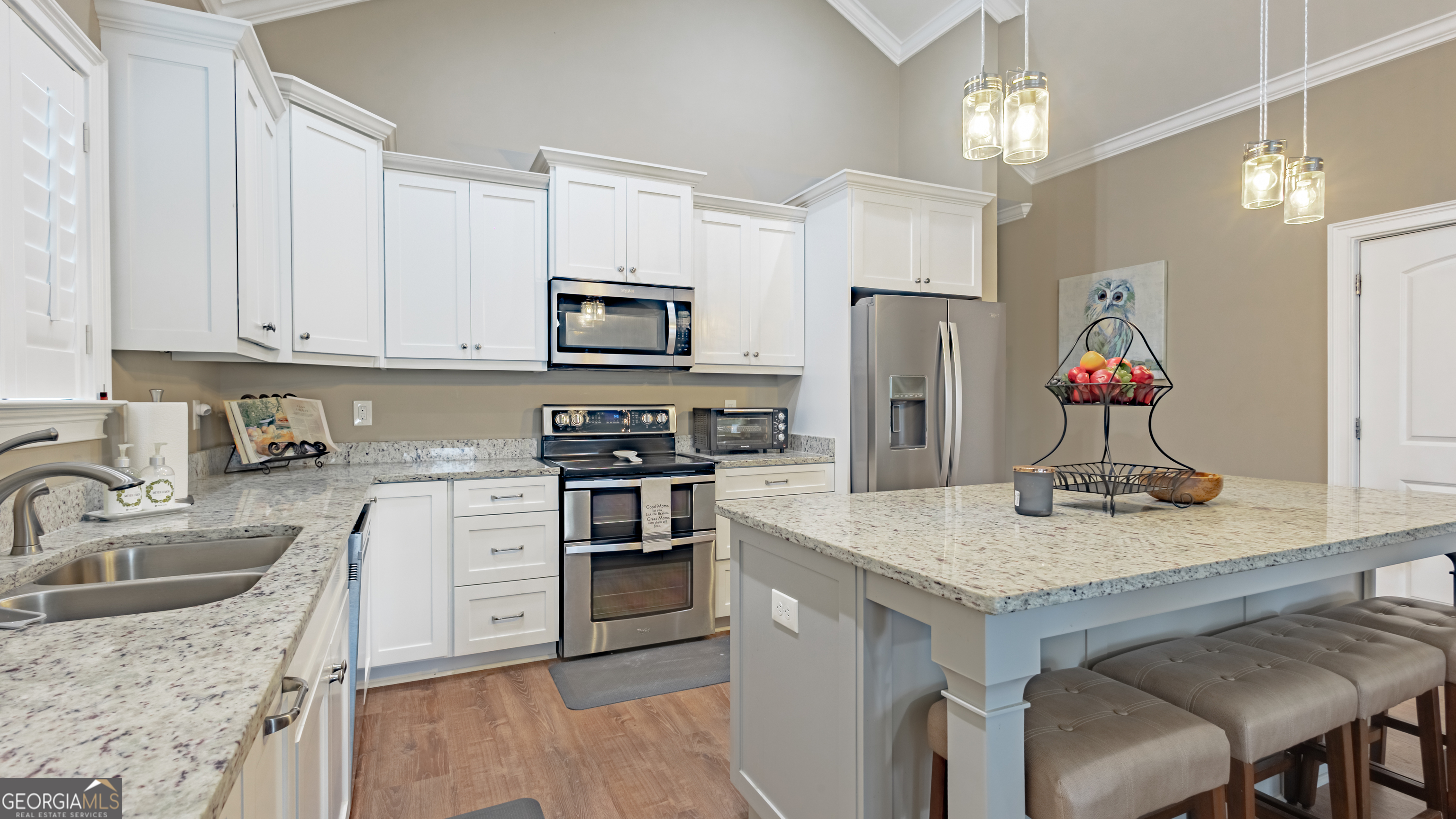 475 Cedar Creek Road North Cordele, GA 31015 - Photo 32 of 50 a kitchen with kitchen island granite countertop a sink cabinets stainless steel appliances and a counter top space