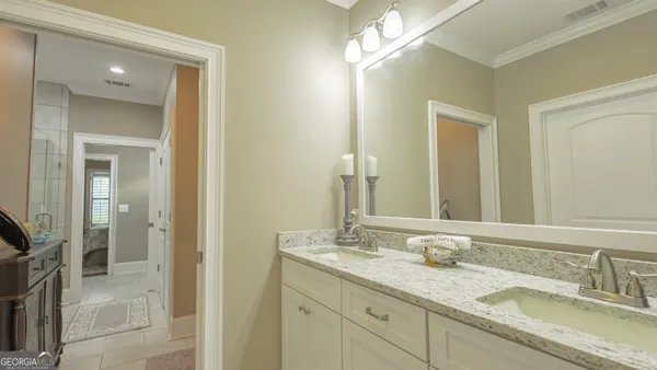 a bathroom with double sink and a mirror