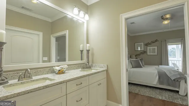 a en suite bathroom with double sink and a mirror