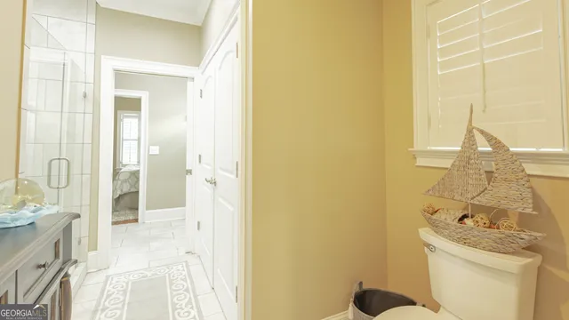 a bathroom with a granite countertop sink a toilet and shower