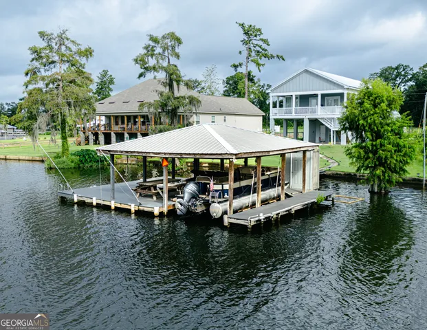 a view of a house with pool and chairs