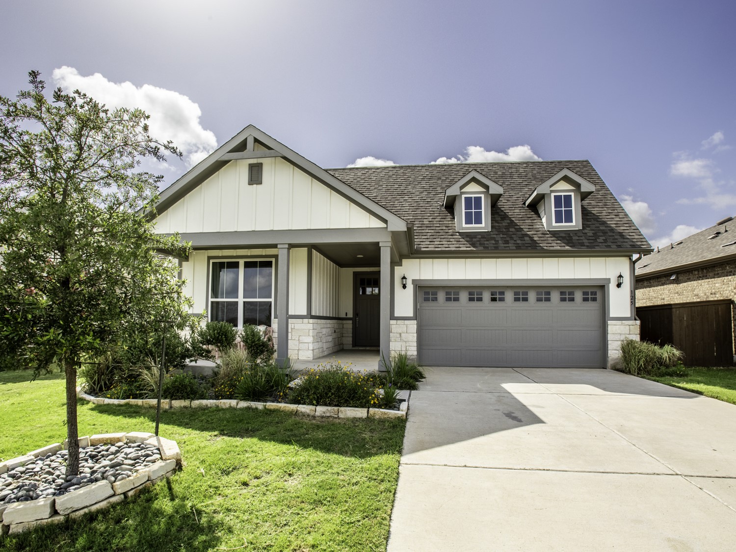 a front view of a house with garden