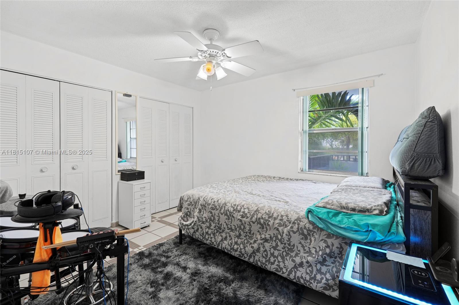 2498 Southwest 17th Avenue, Unit 4311 Miami, FL 33133 - Photo 6 of 19 a bedroom with a bed and a chandelier