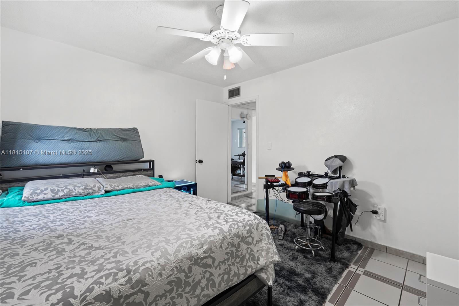2498 Southwest 17th Avenue, Unit 4311 Miami, FL 33133 - Photo 7 of 19 a bedroom with a bed and a table in it