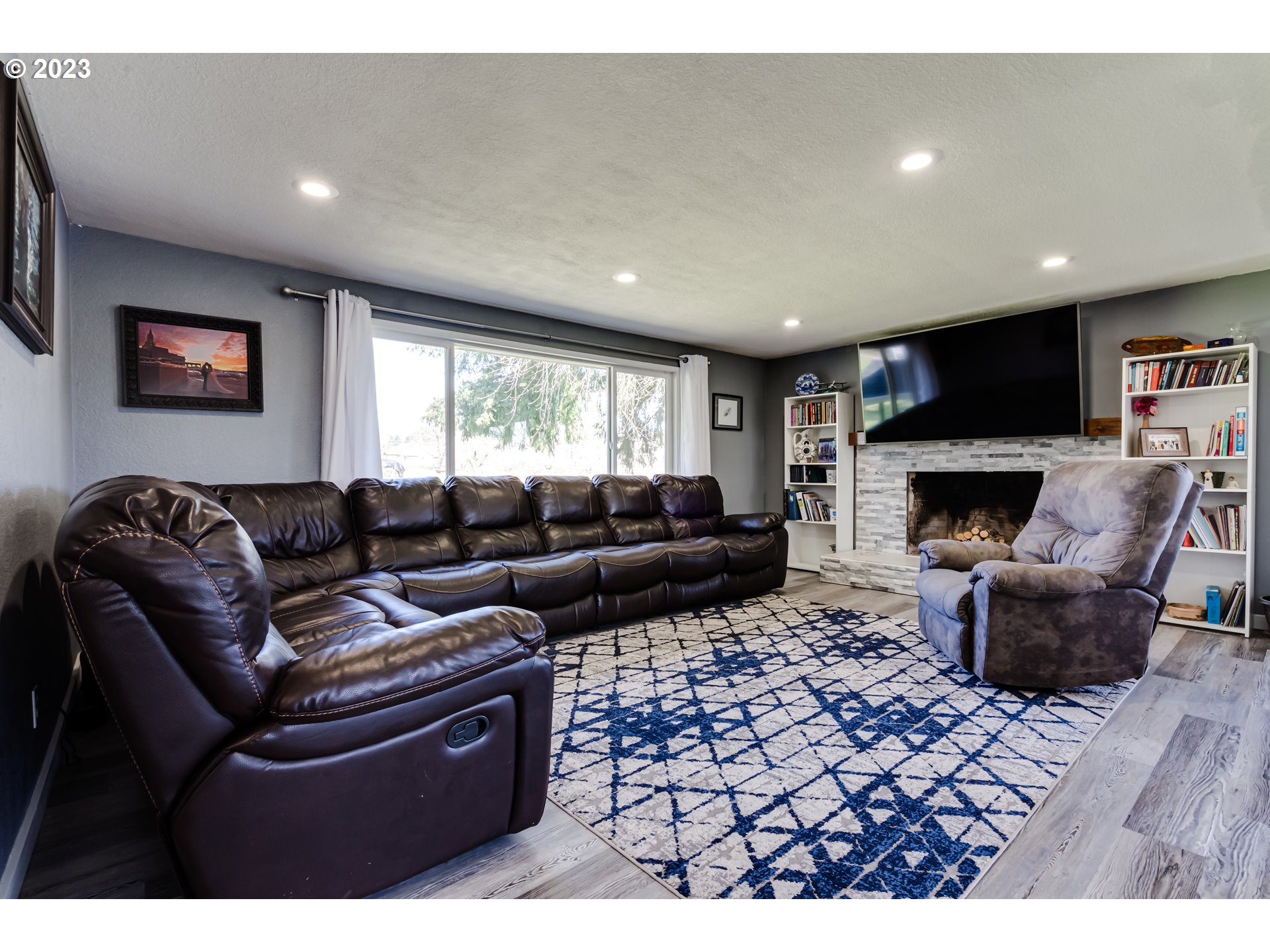 1109 Linda Lane Springfield, OR 97478 - Photo 6 of 30 a living room with furniture a flat screen tv and a fireplace