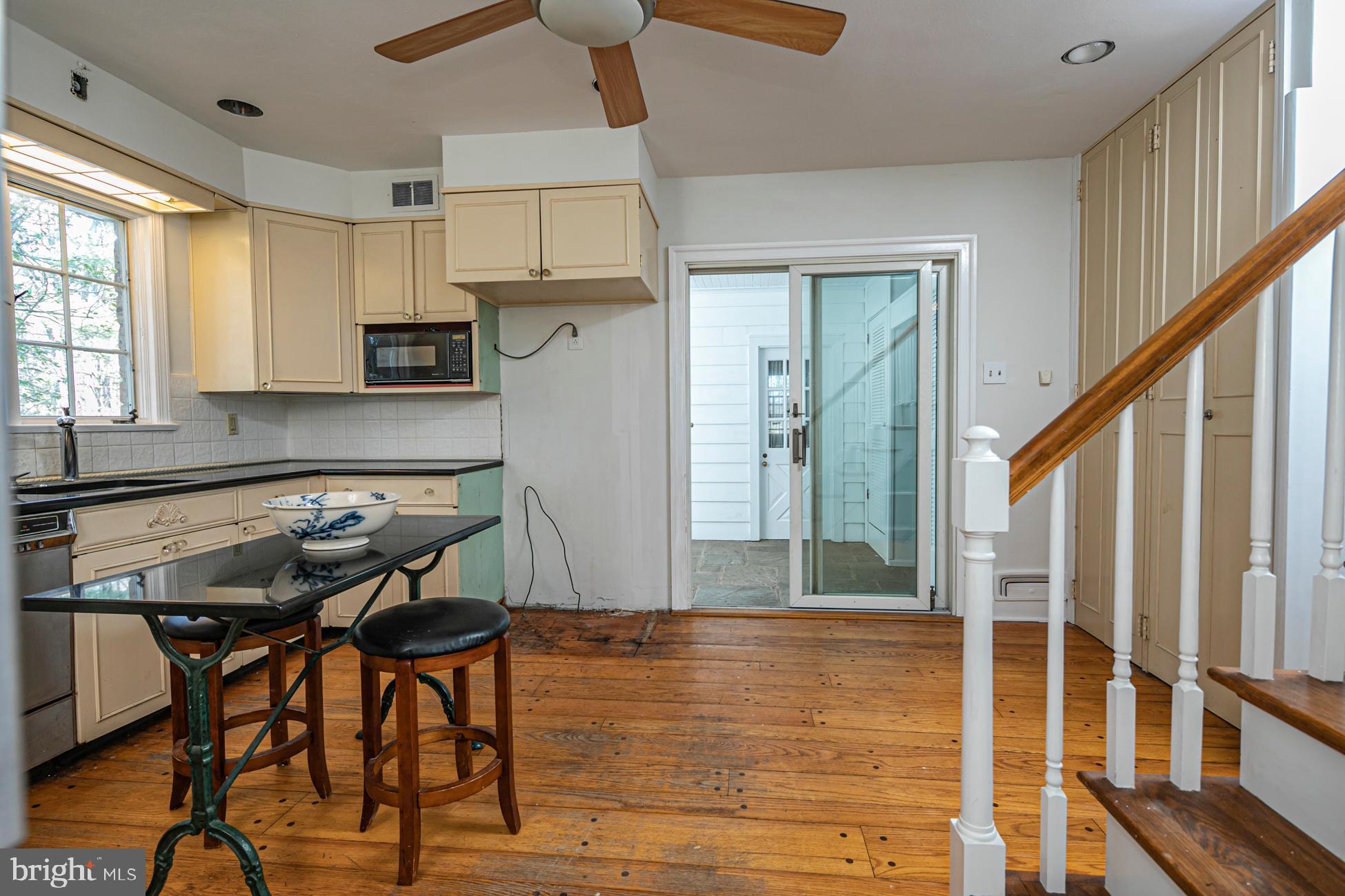 80 Carson Road Princeton, NJ 08540 - Photo 22 of 31 a kitchen with stainless steel appliances dining table chairs and cabinets