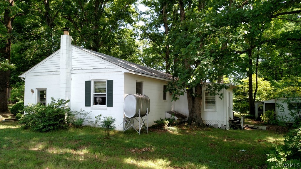 16397 Old Ridge Road Montpelier, VA 23192 - Photo 4 of 10 a backyard of a house with table and chairs and potted plants