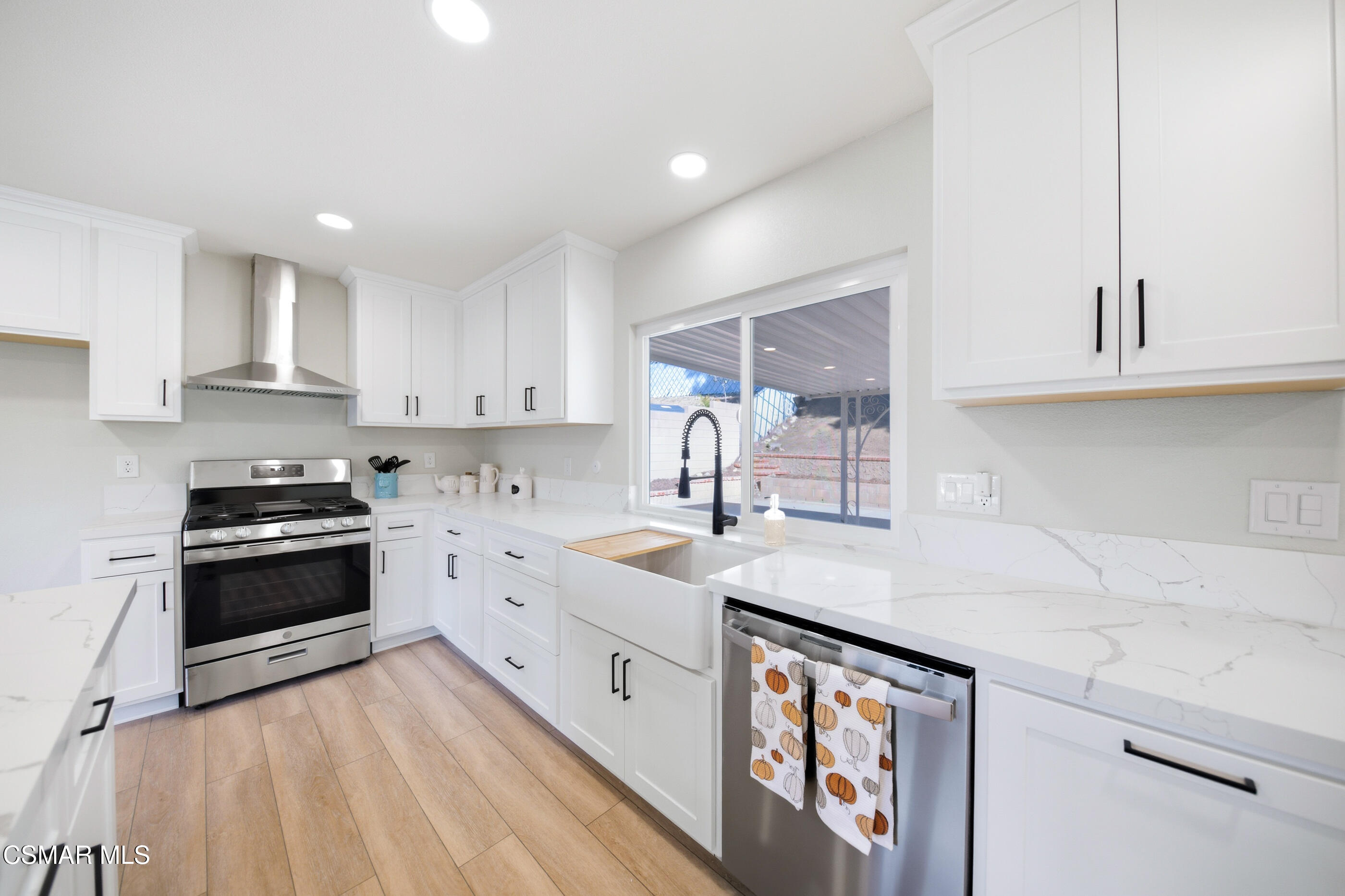 6417 Keystone Street Simi Valley, CA 93063 - Photo 11 of 31 a kitchen with stainless steel appliances granite countertop a sink stove and cabinets