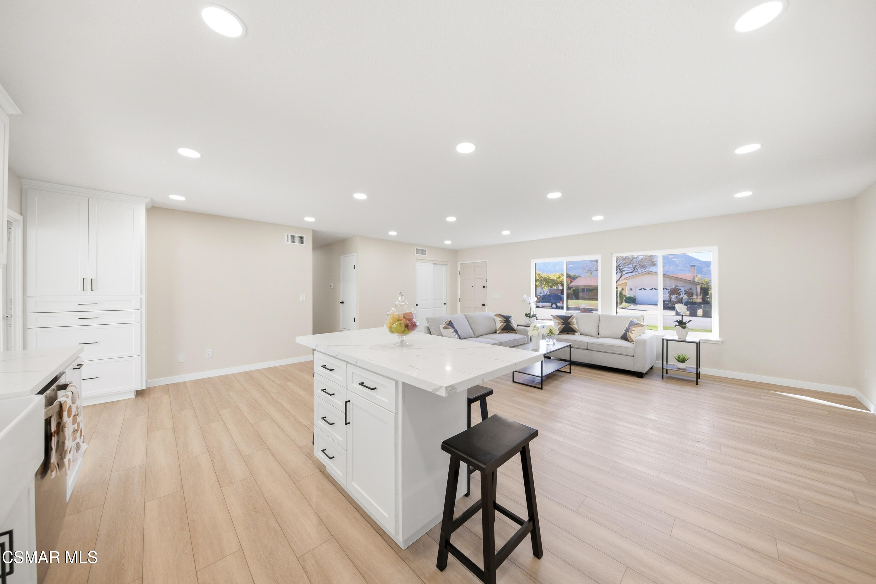 6417 Keystone Street Simi Valley, CA 93063 - Photo 13 of 31 a living room with couches and kitchen view with wooden floor