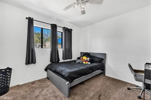 a bedroom with furniture and a large window