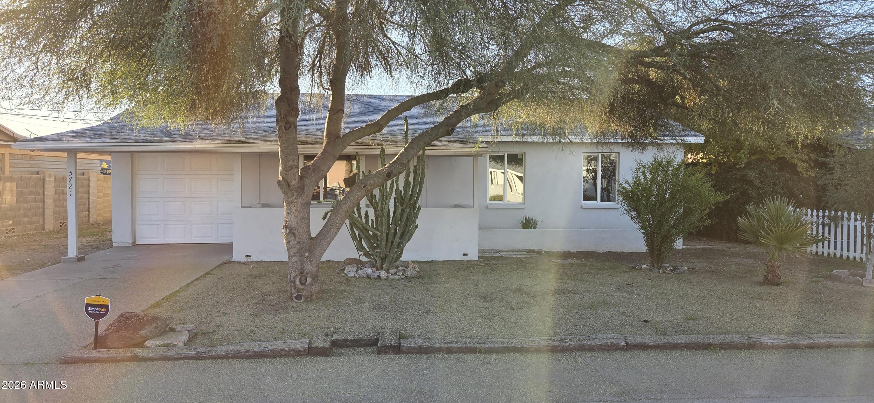5721 West Cheery Lynn Road Phoenix, AZ 85031 - Photo 3 of 20 a front view of a house with a yard and garage