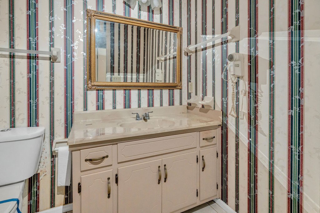 5800 Yellow Creek Road Murrayville, GA 30564 - Photo 17 of 29 a bathroom with a granite countertop sink and a mirror