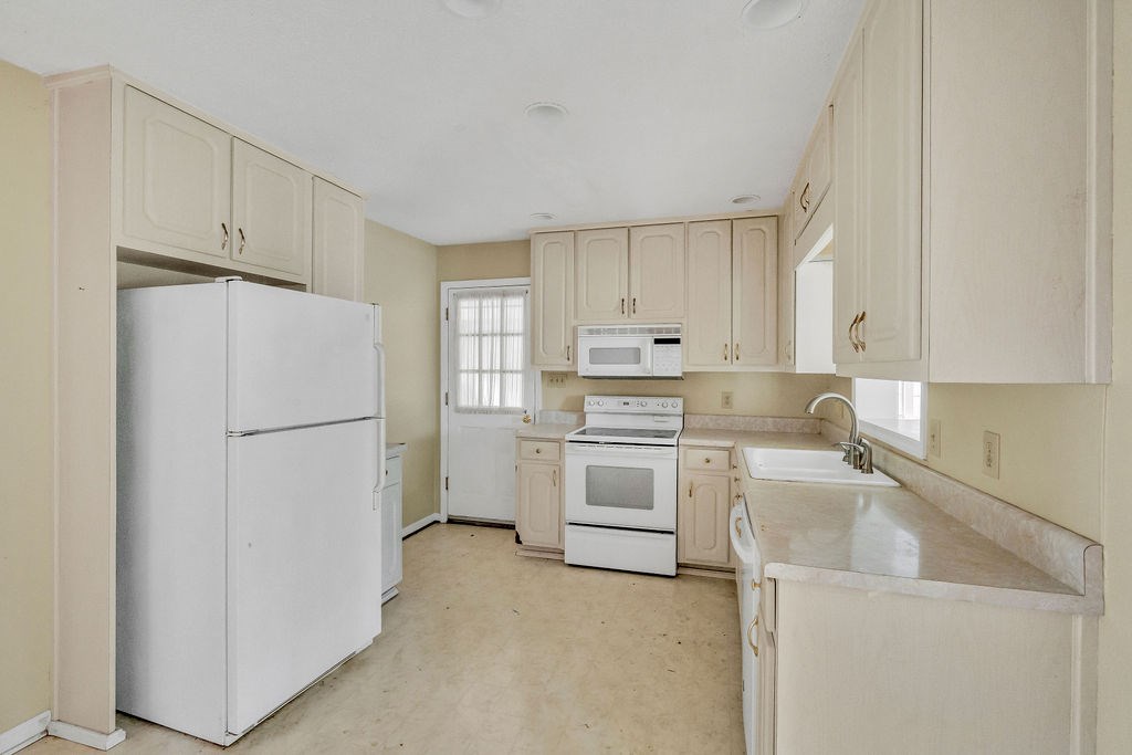 5800 Yellow Creek Road Murrayville, GA 30564 - Photo 4 of 29 a kitchen with white cabinets and white appliances