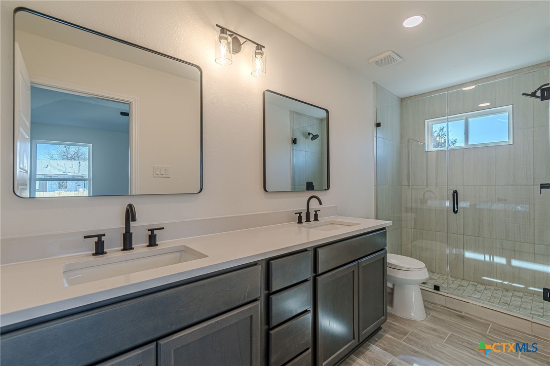 403 North Bauer Street Seguin, TX 78155 - Photo 12 of 27 a bathroom with a sink and a mirror