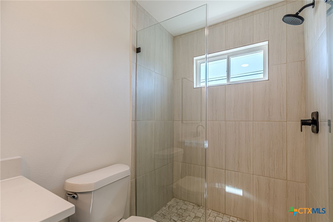 403 North Bauer Street Seguin, TX 78155 - Photo 13 of 27 a bathroom with a toilet and shower