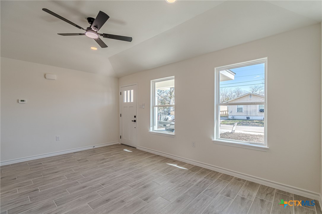 403 North Bauer Street Seguin, TX 78155 - Photo 20 of 27 a view of an empty room with a window and wooden floor