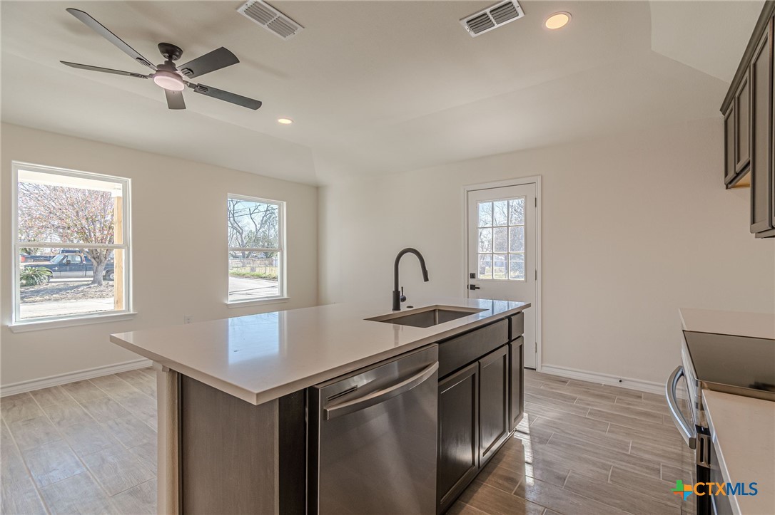403 North Bauer Street Seguin, TX 78155 - Photo 2 of 27 a kitchen that has a sink a stove and a window