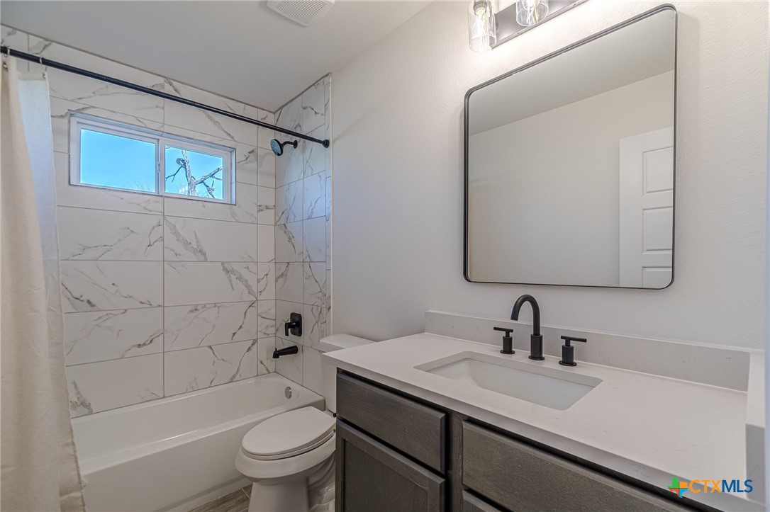 403 North Bauer Street Seguin, TX 78155 - Photo 3 of 27 a bathroom with a sink a toilet and shower