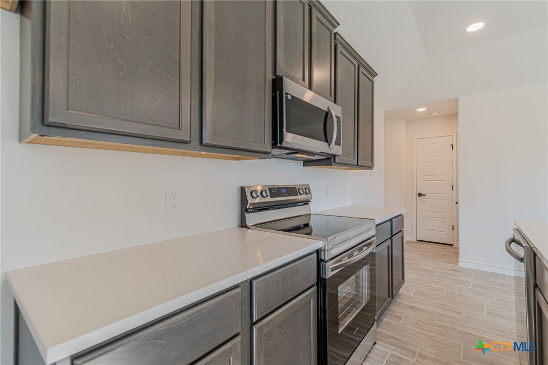 403 North Bauer Street Seguin, TX 78155 - Photo 8 of 27 a kitchen with stainless steel appliances a sink dishwasher stove and microwave