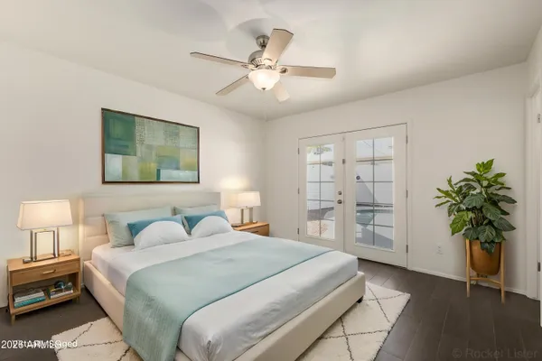 a bedroom with a bed and a potted plant