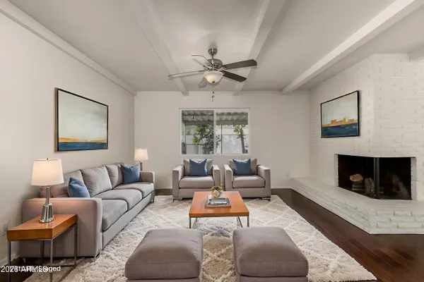 a living room with furniture and a fireplace