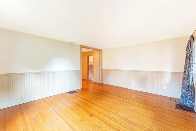 a view of an empty room and wooden floor