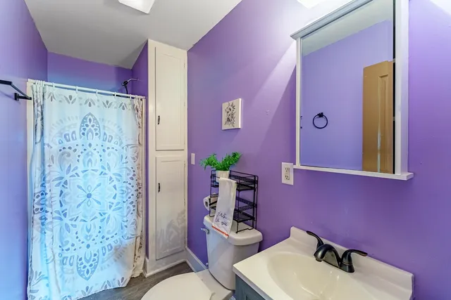 a bathroom with a sink toilet and shower