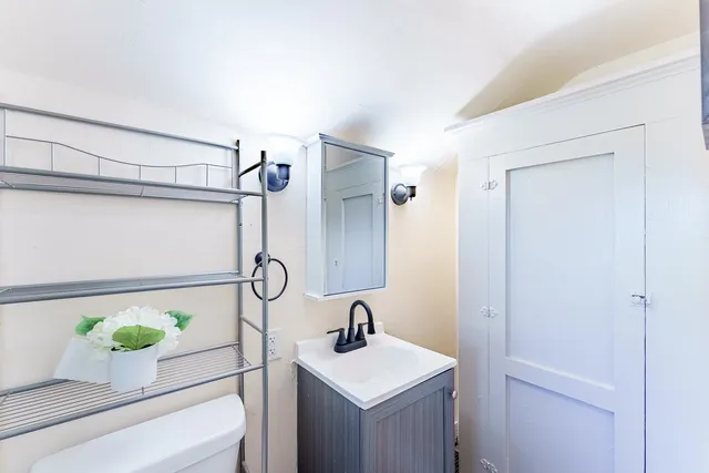 a bathroom with a sink vanity and mirror
