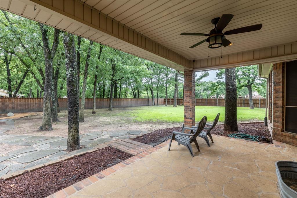 320 Rustic Oaks Road Combine, TX 75159 - Photo 5 of 40 Fenced backyard featuring a patio area and a ceiling fan