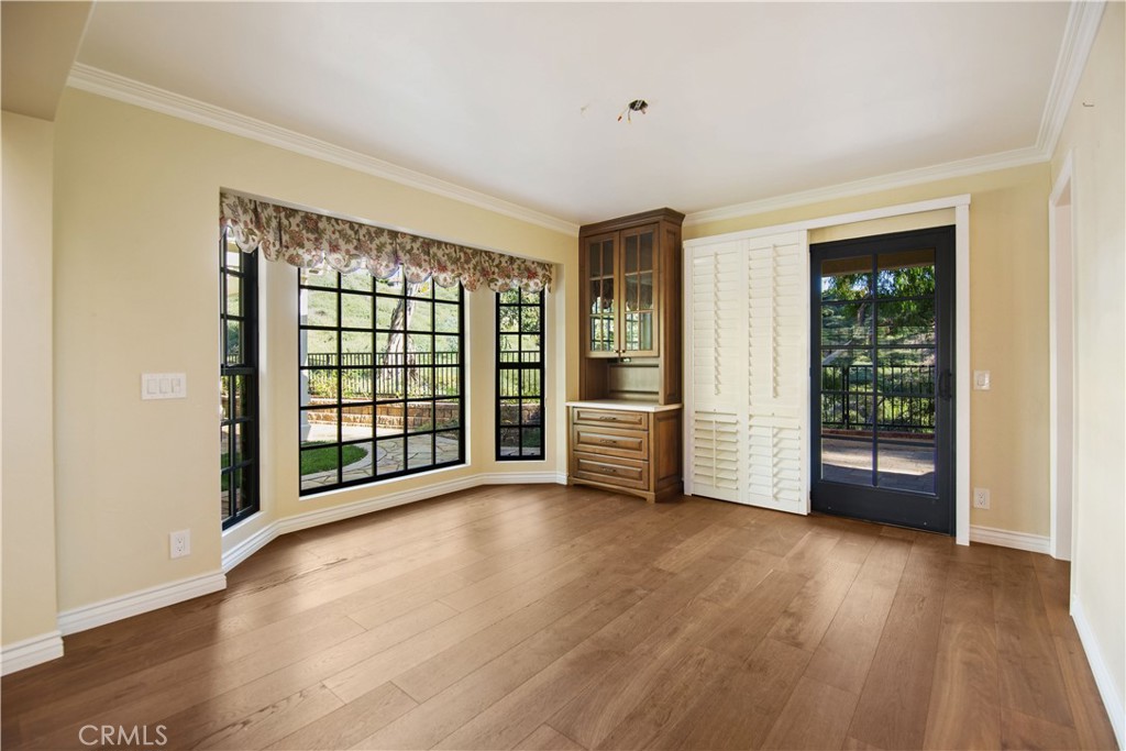 24965 Danamaple Dana Point, CA 92629 - Photo 11 of 72 a view of an empty room with a window and wooden floor