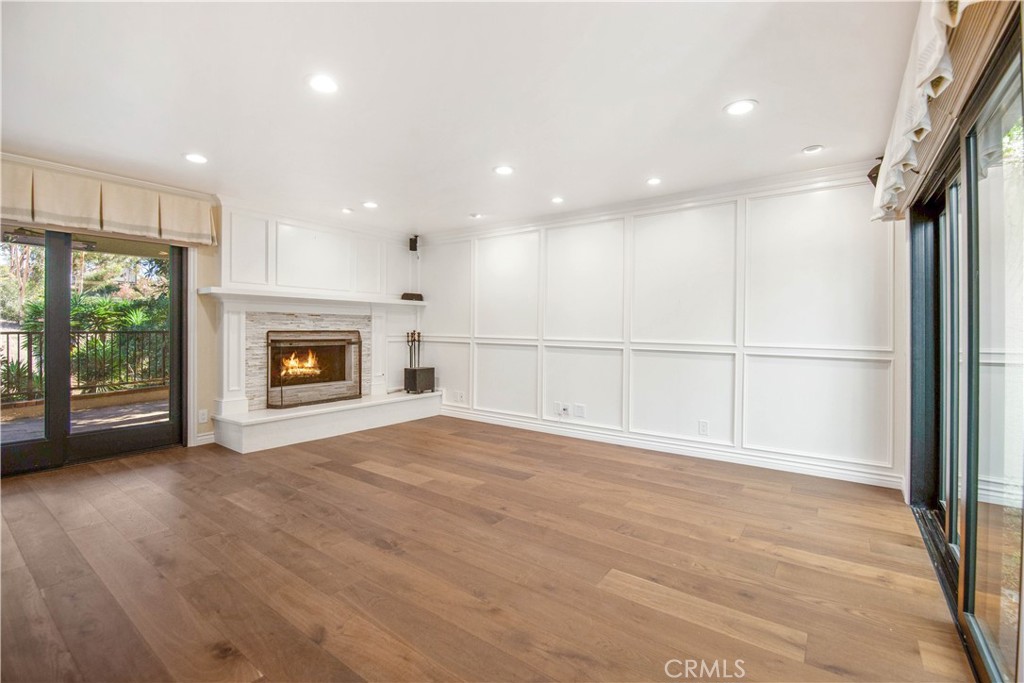 24965 Danamaple Dana Point, CA 92629 - Photo 14 of 72 a view of empty room with wooden floor and fireplace